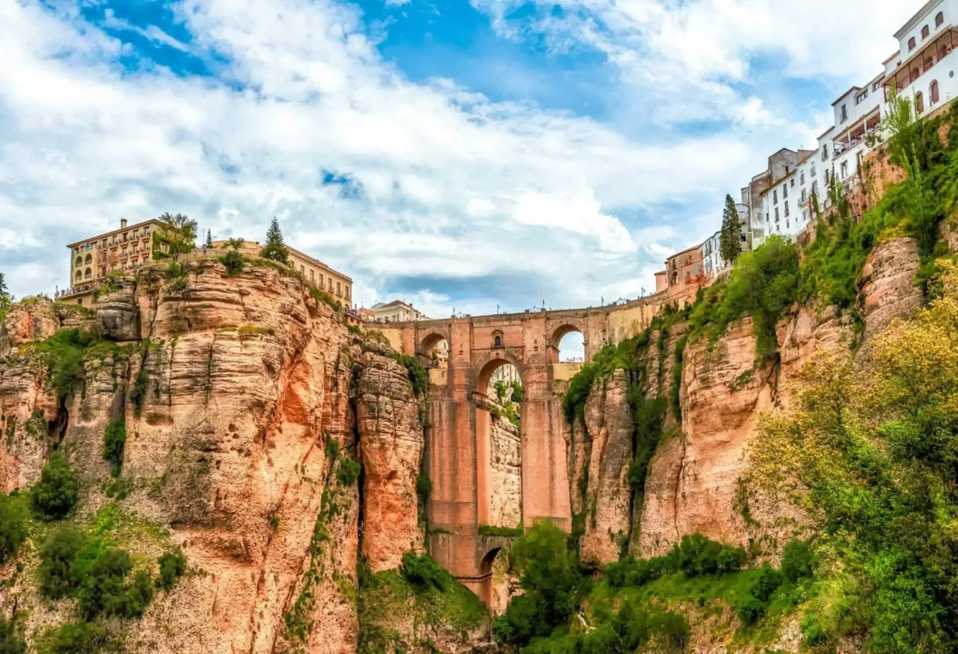 Iconic stone bridge spanning a deep gorge between cliffs in a historic Spanish town.