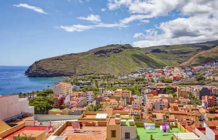 San Sebastián de la Gomera is the capital of and municipality on La Gomera in the Canary Islands, Spain. It also hosts the main harbour. The port serves ferry routes to the islands of Tenerife, La Palma and El Hierro. Streets include Calle Real and F. Olsen. A bus station named Estación de Guaguas is used for bus lines throughout the island; it is located on Avenida Quinta Centenario.